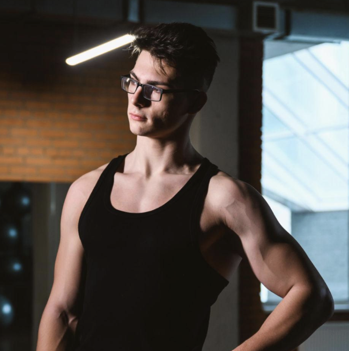 A QOOM coach standing confidently in a training studio